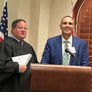 A judge and a smiling man