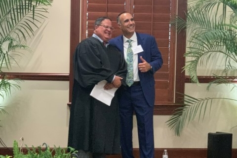 Judge shaking hands with smiling man