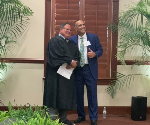 Judge shaking hands with smiling man