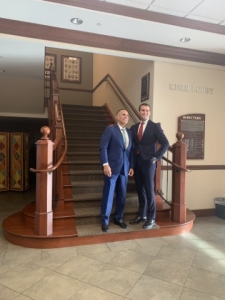 Two smiling men on stairs